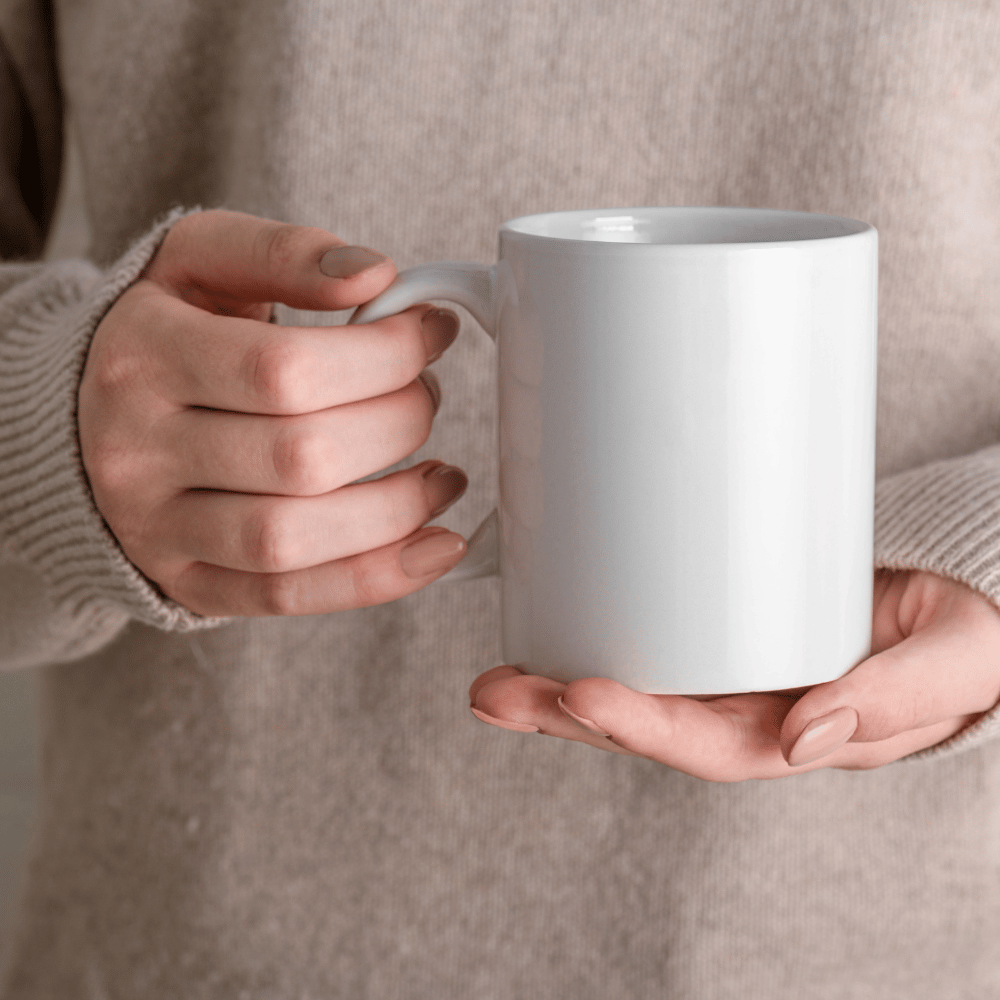 hand holding a coffee mug