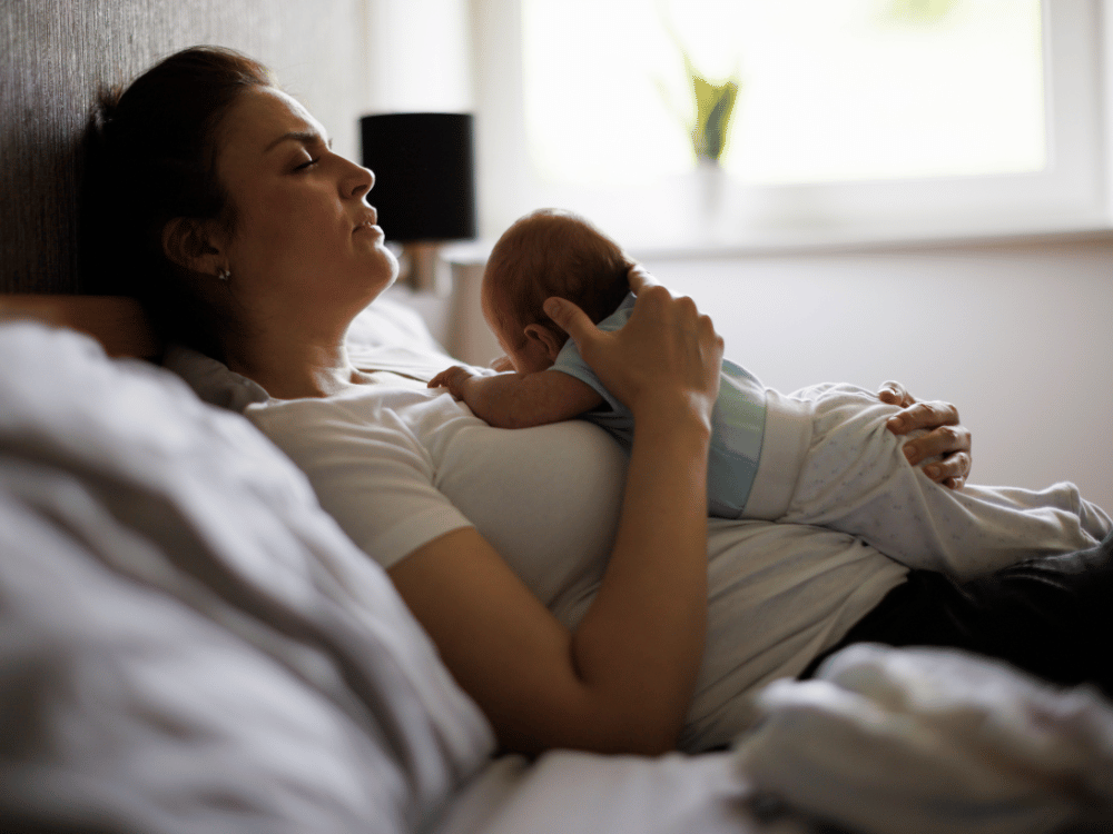 woman holding newborn baby on chest