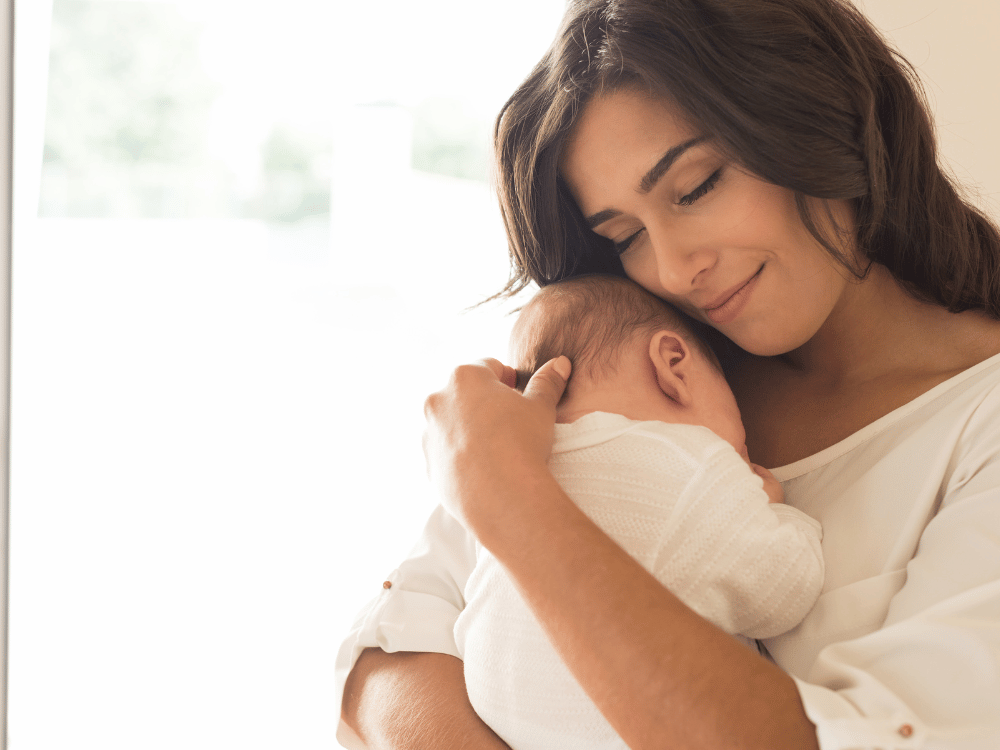 woman cradling newborn baby