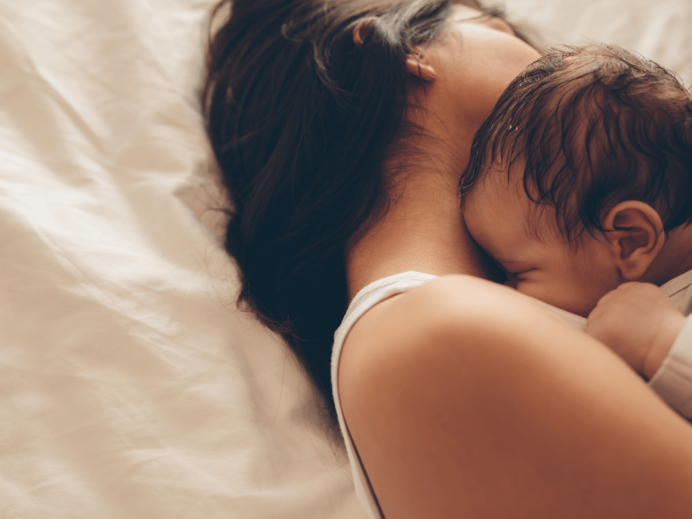 woman hugging newborn baby