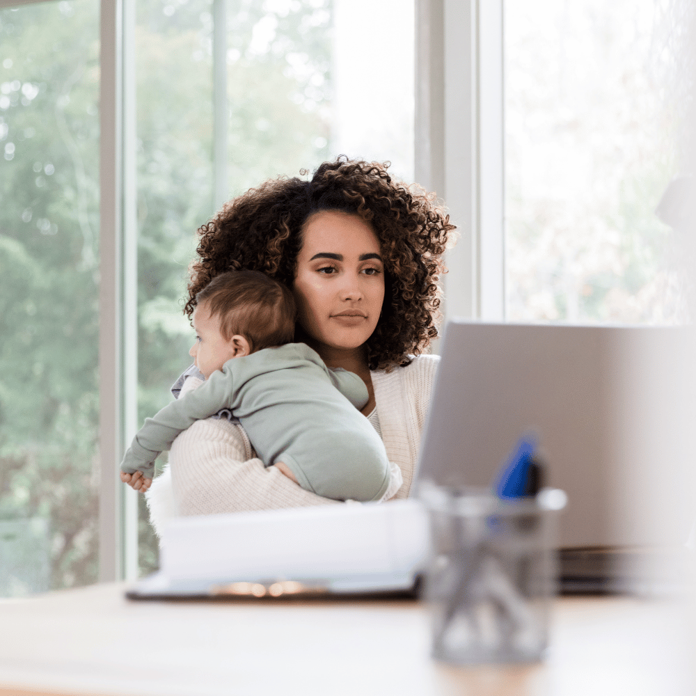 woman holding baby at laptop